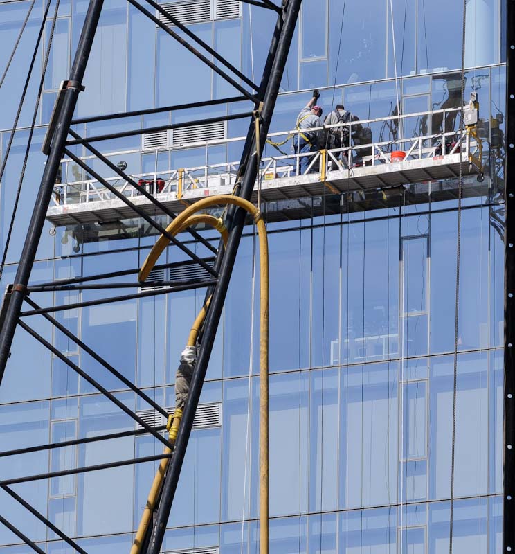 Suspended scaffold for window maintenance for high-rise buildings.