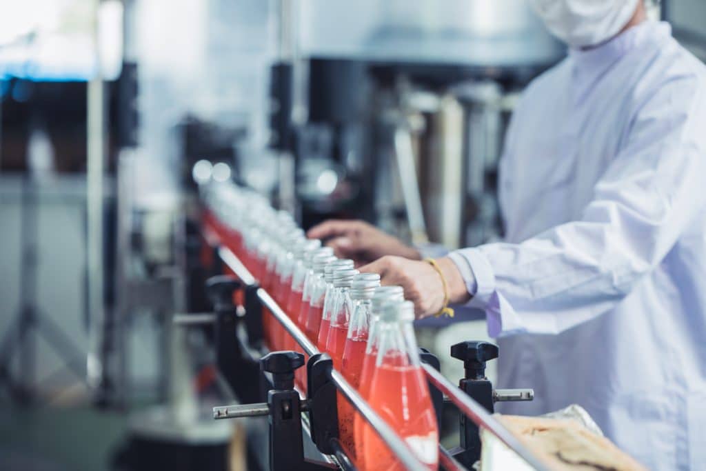 Maintaining GMP and cGMP Compliance is explained for industries like food manufacturing (bottling shown in this file photo) at 1stReporting.com.