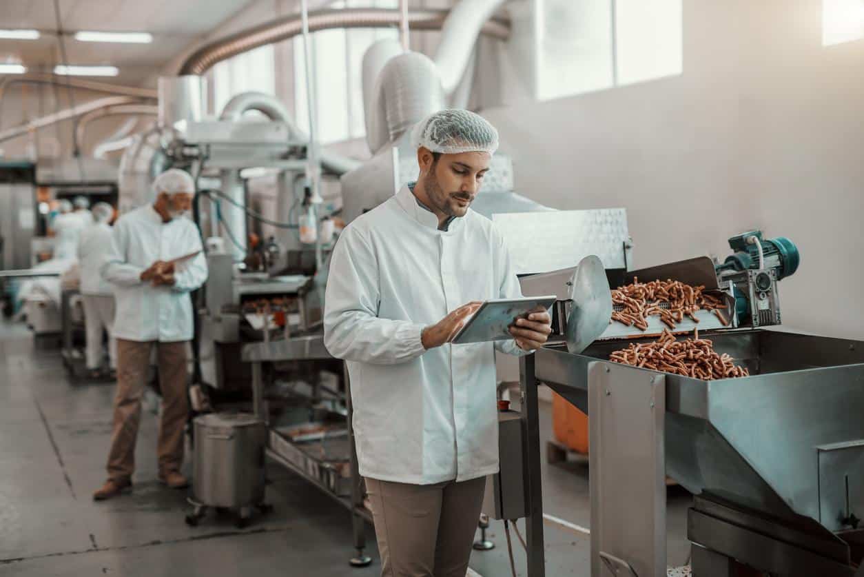 A food gmp audit checklist is used by an auditor in a food manufacturing facility.