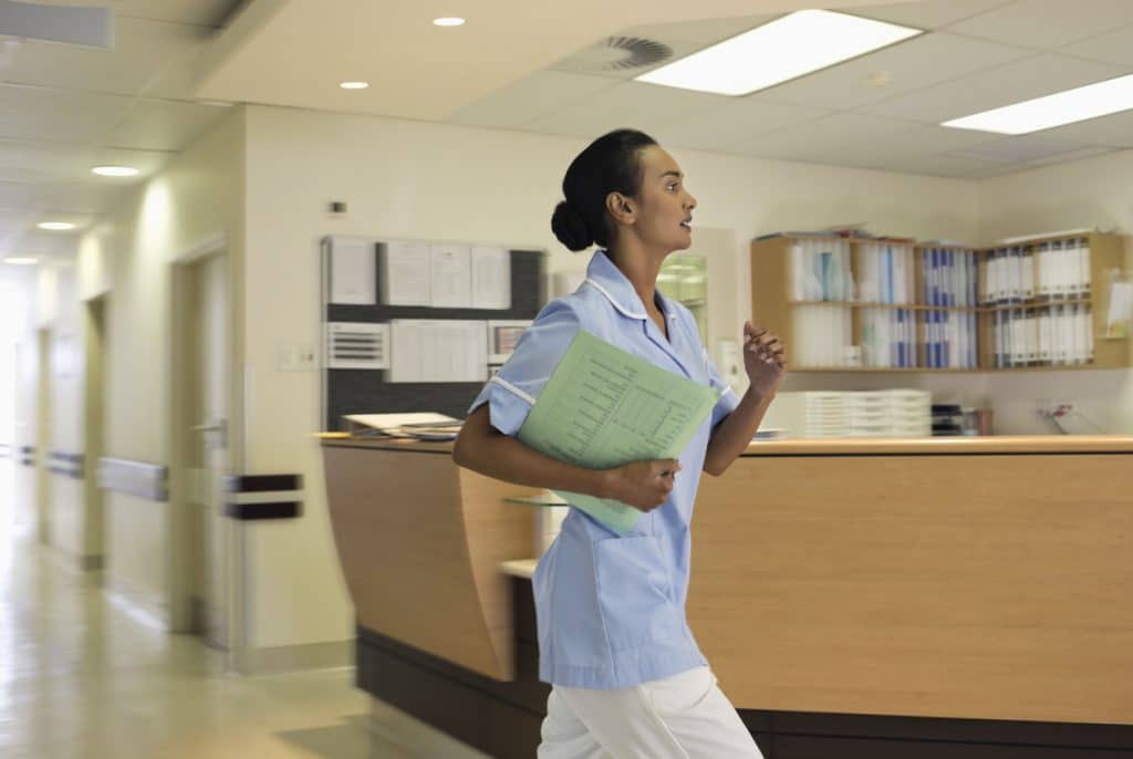 A nurse rushes to complete an Incident Report. Learn about completing incident reports in Nursing at 1st Reporting (dot com).
