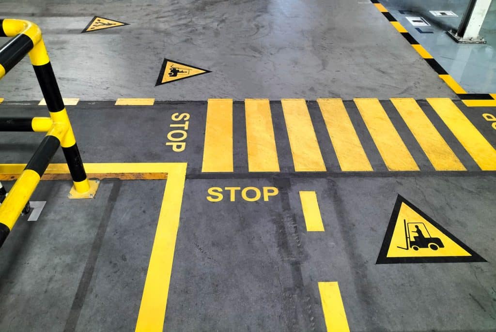 The best safety tips for warehouse workplaces include having strict lanes for pedestrian and vehicular traffic, as shown in this file photo. Learn more at 1stReporting.com.