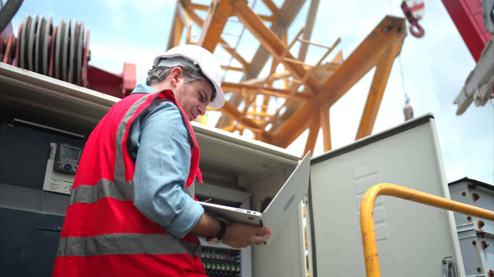 An electrical engineer uses a tablet for field reporting. Learn more about field reporting at 1stReporting.com.