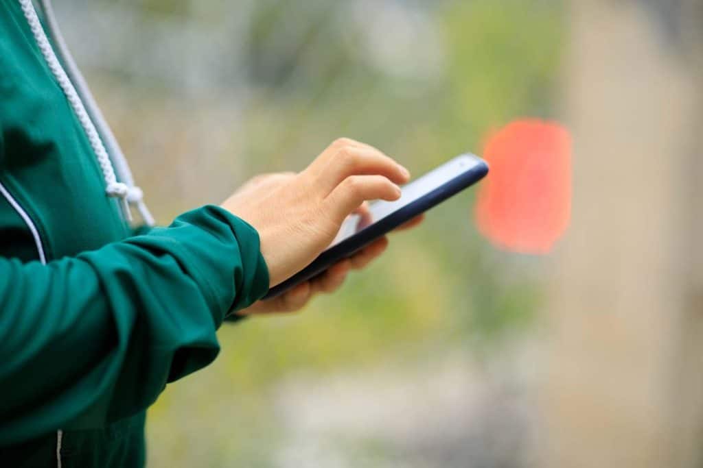 A municipal worker completes part of a pre-event checklist on their mobile device. Learn more about mobile reporting at 1stReporting.com.