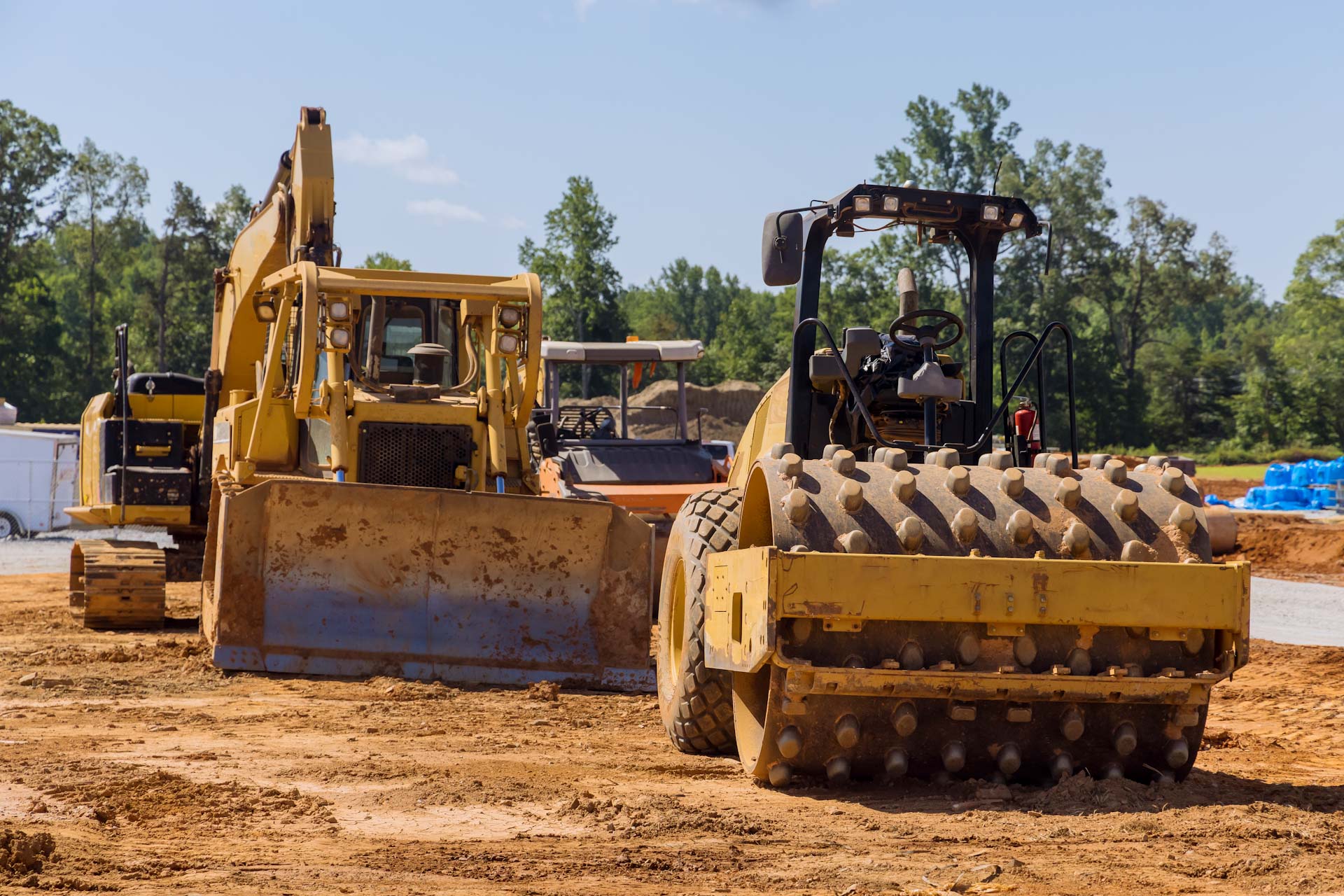 Construction management resources to help manage safety and construction equipment like those shown in this image of road construction. Learn more at 1stReporting.com.