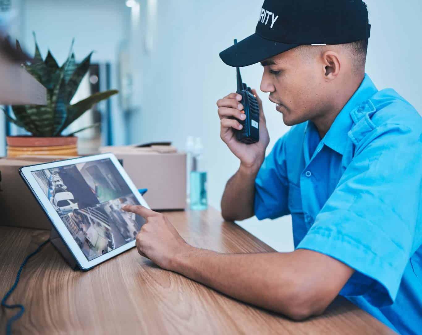 A security agent accesses security resources on his tablet. Learn more about mobile security reporting resources at 1stReporting.com.